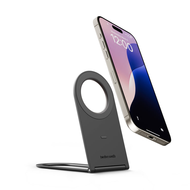 Wireless charging stand with a smartphone on a white background