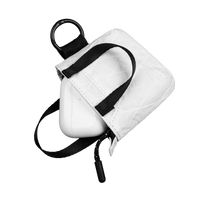 White tote with black strap on a white background and AirPods 