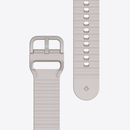 Close-up of a light dune watch strap with buckle on a white background