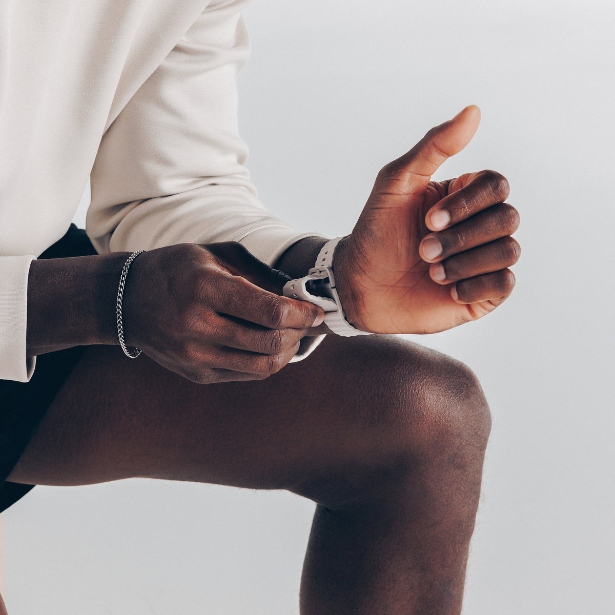 Person wearing a dune band on one hand with a plain background