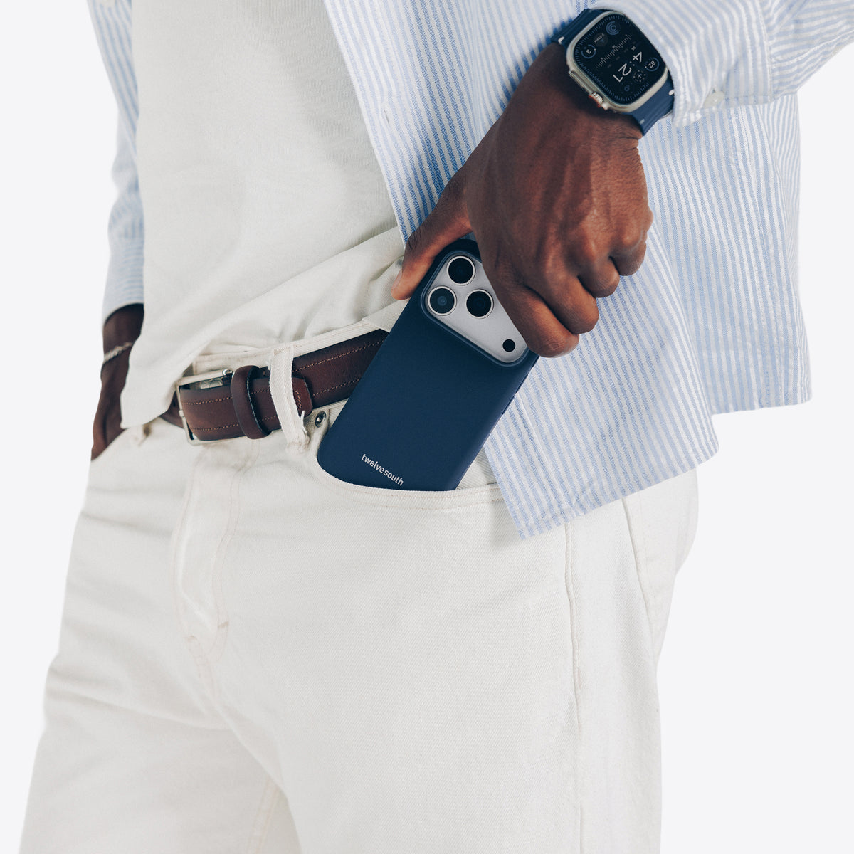 Person holding a blue phone case with a white shirt and beige pants