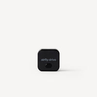 A small black square electronic device with rounded corners and the text 'airfly drive' printed on the front, centered on a light gray background.