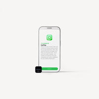 A smartphone centered on a light gray background with a small black CarPlay device in front of it. The phone screen shows the CarPlay welcome interface with a green logo and text.