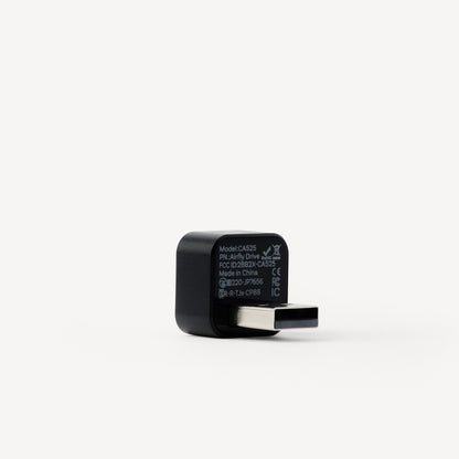 A black USB-C to USB-A adapter with white printed specifications on its side, shown on a clean white background.