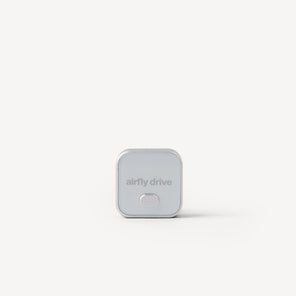 A small square silver device with rounded corners and the text 'airfly drive' on the front, centered on a clean white background.