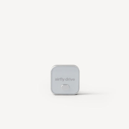 A small square silver device with rounded corners and the text 'airfly drive' on the front, centered on a clean white background.