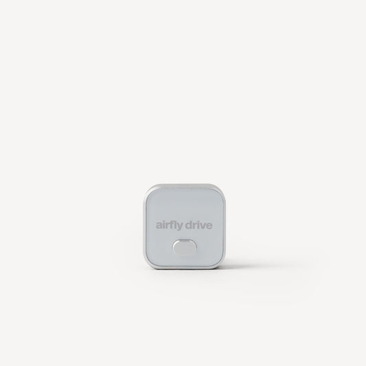 A small square silver device with rounded corners and the text 'airfly drive' on the front, centered on a clean white background.