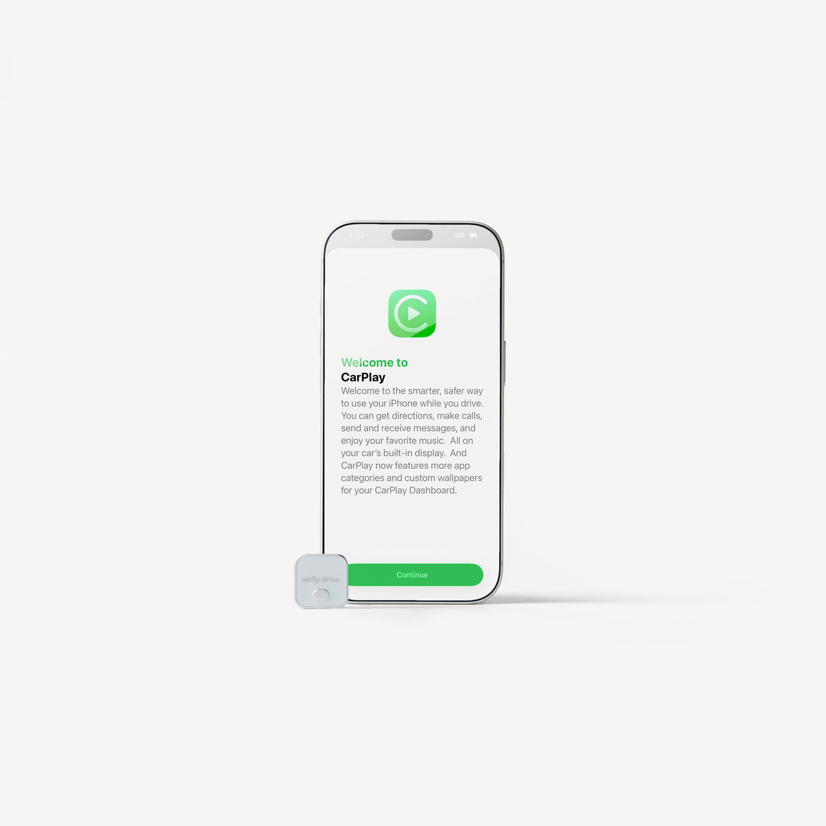 A smartphone centered on a light gray background with a small white CarPlay device in front of it. The phone screen shows the CarPlay welcome interface with green and black text.